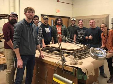 
                Wood Science and Technology students standing around a project
            