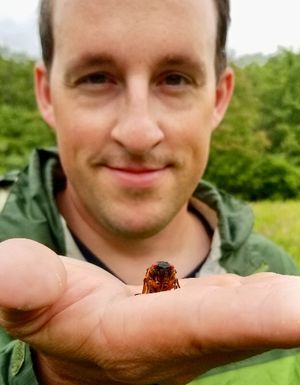 Matt Kasson holding a cicada