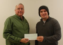Photo of Hunter receiving scholarship award from Miles Stephens. 