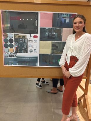 Interior Design student Kasey Helmick stands beside her award winning display, True Colors.