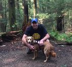Chad in the woods with his dog.