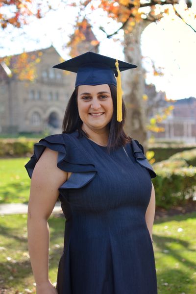 Michelle Duvall wearing a mortarboard and a blue dress