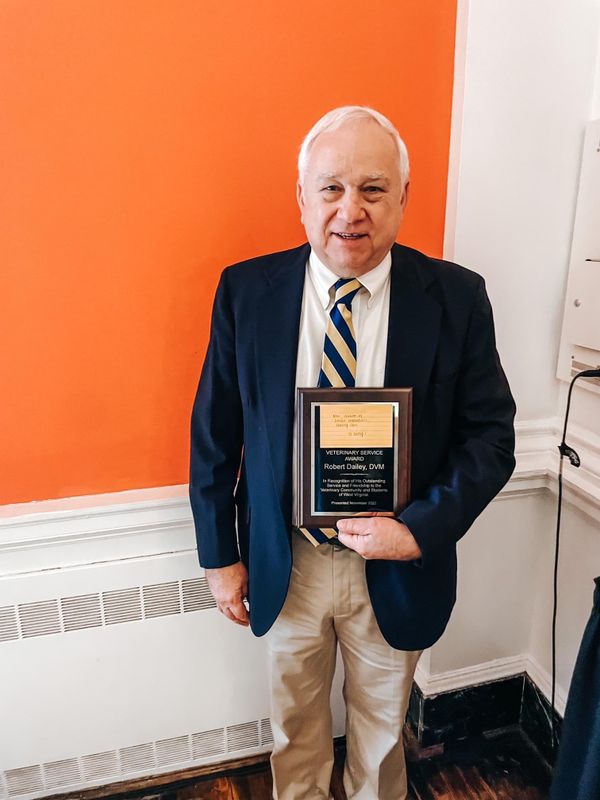 Photo of older man holding award