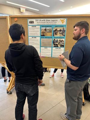 Photo of two men talking in front of research poster.