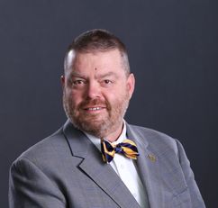Photo of man in tie and suit jacket