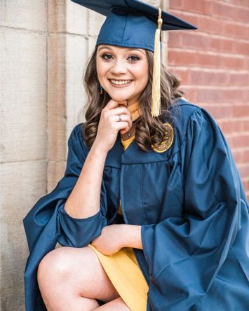 Young woman in cap and gown. 