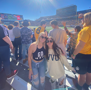 Photo of two women at a football game. 