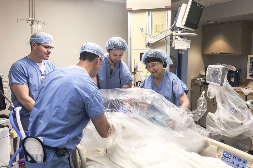 Dr. Matthew Ellison, Dr. Kevin McKillion, Dr. Hong Wang and CRNA Cole Mortellaro, the WVU Medicine anesthesia team practice COVID-19 intubations using the intubation box created in the Innovation Hub. The suite was set up by the trauma and critical care i