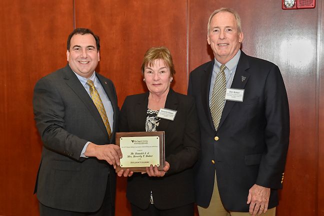 Beverly and Donald Baker receive the Legacy Leader award from Daniel Robison, dean of the West Virginia University Davis College of Agriculture, Natural Resources and Design