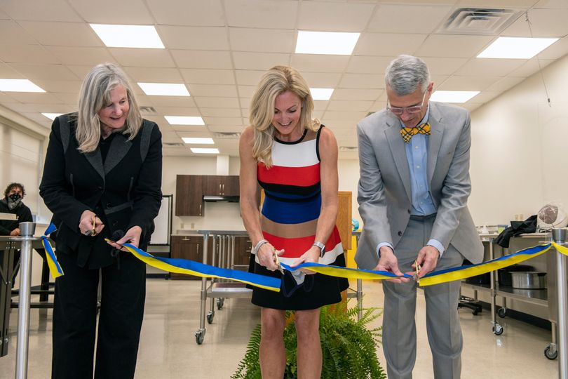 Amy Bircher (center), Beth Shorrock (left) and Darrell Donahue cut the ribbon on the new Amy A. Bircher Textiles Laboratory